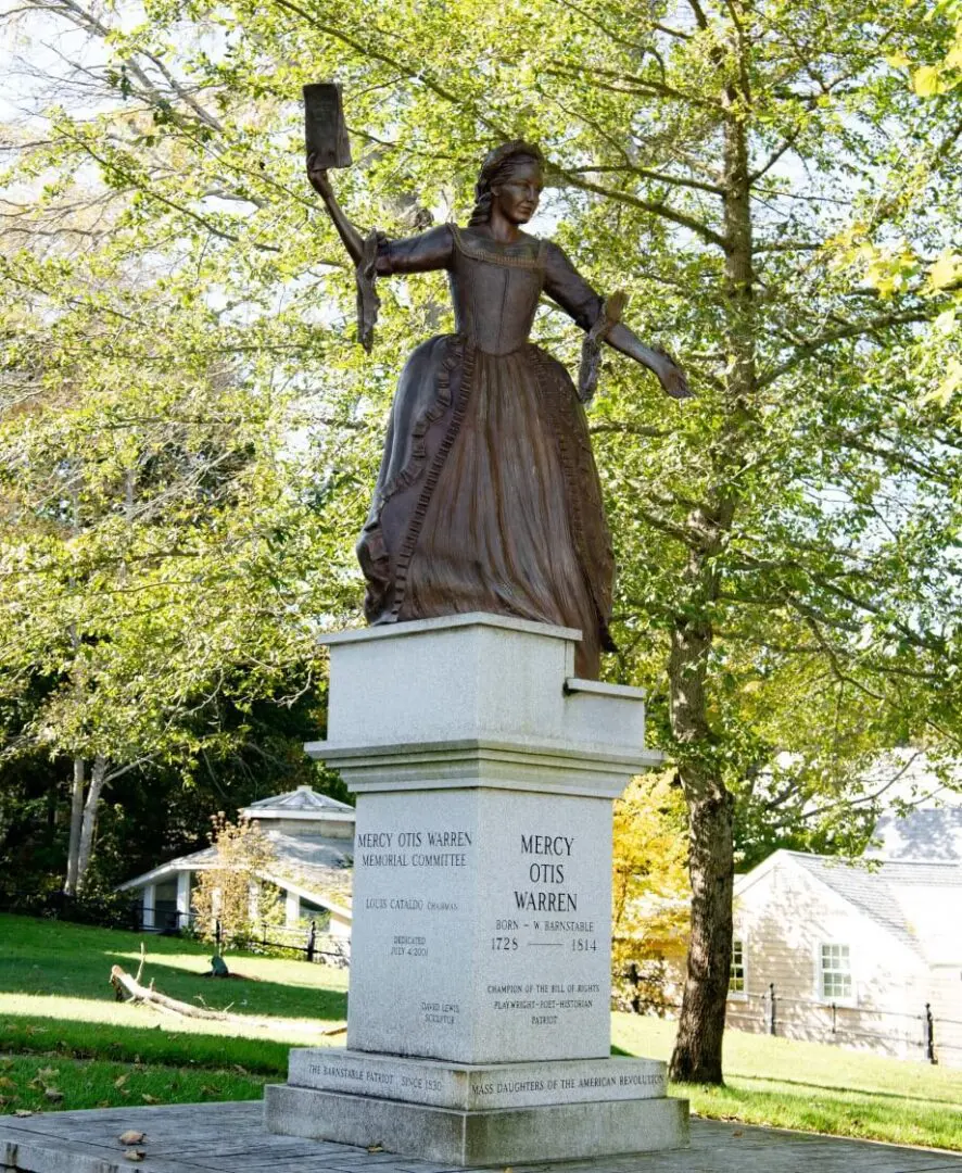 A statue of a woman holding an umbrella.